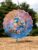 Gorgeous Rainbow Bird Standing Amongst the Flowers Wind Spinner